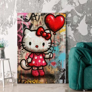 May include: A rectangular wall art print featuring a white cartoon cat with a red bow and a red polka dot dress, holding a large red heart-shaped balloon. The background is a textured urban graffiti wall with drips of paint and a small silhouette figure.