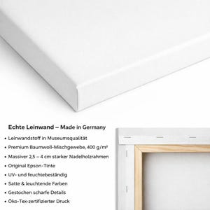 May include: A white canvas print with a wooden frame, showing a corner view. The text "Echte Leinwand - Made in Germany" is visible, along with bullet points describing the canvas material, ink, and frame.