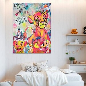 May include: A colorful canvas art print featuring characters from The Lion King. The artwork includes Simba, Timon, Pumbaa, and Rafiki, with the words "Born to be King" in graffiti style. The art is displayed above a white bed.