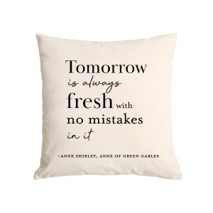 May include: A white throw pillow with black text that reads "Tomorrow is always fresh with no mistakes in it - ANNE SHIRLEY, ANNE OF GREEN GABLES".