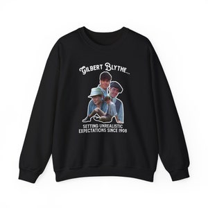 May include: Black sweatshirt with a white graphic print of a collage of Gilbert Blythe from the show Anne with an E. The text reads "Gilbert Blythe... Setting Unrealistic Expectations Since 1908."