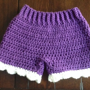 May include: Purple crochet shorts with a white crocheted lace trim.