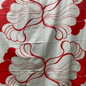 May include: White fabric with a repeating pattern of red, organic shapes. The shapes are reminiscent of stylized flowers or leaves.