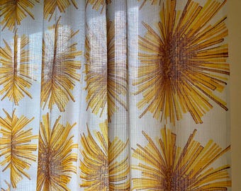 May include: White sheer curtains with a yellow and brown geometric pattern of stylized sunbursts.