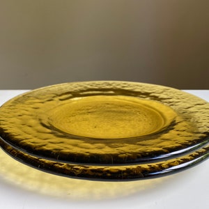 May include: Two amber glass plates with a textured surface. The plates are stacked on top of each other.