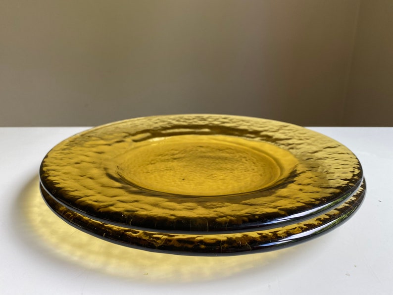 May include: Two amber glass plates with a textured surface. The plates are stacked on top of each other.