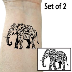 May include: Set of two black and white temporary tattoos featuring an elephant with intricate floral designs.  "Set of 2" is written in black text at the top of the image.