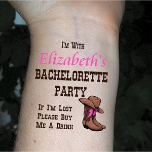May include: A temporary tattoo with the text "I'm with Elizabeth's Bachelorette Party. If I'm lost please buy me a drink." and a cartoon image of a brown cowboy boot with a pink flower.