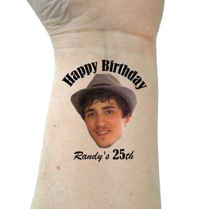 May include: A temporary tattoo with a photo of a person wearing a hat and the text "Happy Birthday Randy's 25th".