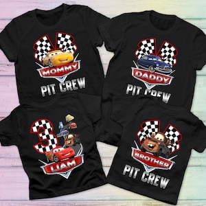 May include: Four black t-shirts with Cars characters and the text "Mommy Pit Crew", "Daddy Pit Crew", "Liam" and "Brother Pit Crew".