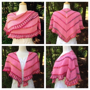May include: A pink knitted shawl with a colorful striped pattern and a scalloped edge. The shawl is draped over a white mannequin.