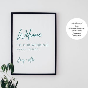 May include: A teal welcome sign with the text "Welcome to our wedding! 09.16.23 | Detroit Jenny - Alex". The sign is framed in black and is hanging on a white wall.