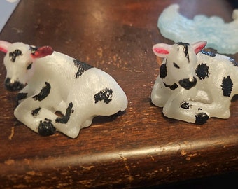 Small resin holstein cow laying down