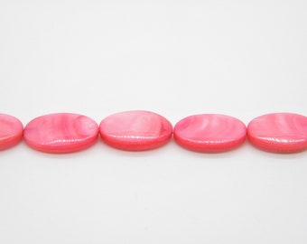 May include: A strand of oval-shaped pink shell beads. The beads have a smooth, glossy finish and a subtle swirl pattern.