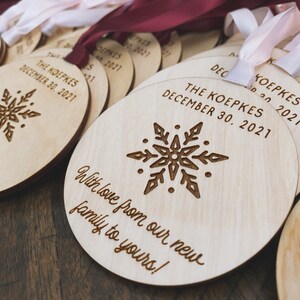 May include: A set of round wooden ornaments with a snowflake design and the text "The Koepkes December 30, 2021" and "With love from our new family to yours!"
