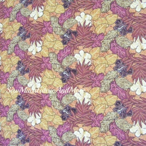 May include: A fabric with a repeating pattern of brown, pink, and white hibiscus flowers and leaves on a peach background.