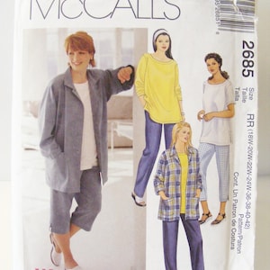 May include: McCall's Womanstyle sewing pattern featuring various women's outfits. The pattern includes a gray jacket and capri pants, a yellow long-sleeve top with blue pants, a white top with plaid pants, and a plaid jacket with a yellow top and blue pants. Size RR (18W-20W-22W-24W-36-38-40-42).