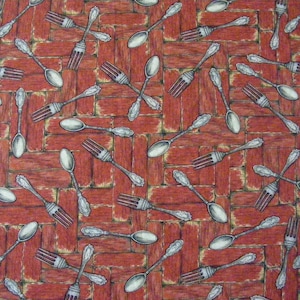 May include: A red and white patterned fabric with a repeating design of silver forks and spoons. The forks and spoons are arranged in a diagonal pattern.