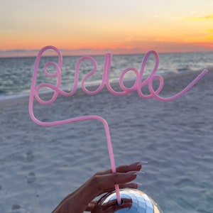 May include: Pink bendy straw shaped to spell "Hello" with a silver disco ball cup.
