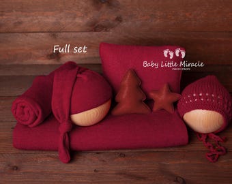 May include: A full set of newborn photography props in burgundy. The set includes a knitted hat, a knitted wrap, a pillow, a tree, and a star. The pillow has the text "Baby Little Miracle Photo Props" printed on it.