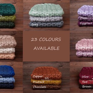May include: A collection of 23 colors of chunky knit baby blankets. The blankets are arranged in rows of three, with each row featuring a different color palette. The colors include emerald, olive, green, beige, ivory, peach, mint, lilac, plum, light grey, grey, eggplant, cobalt, blue, navy, copper, mustard, chocolate, light pink, dirty pink, wine, red, and brown.