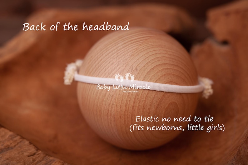 May include: White elastic headband with the text "Baby Little Miracle" on it. The headband is shown on a wooden surface. The text "Elastic no need to tie (fits newborns, little girls)" is also visible.