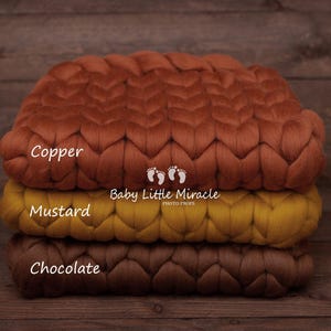 May include: Three chunky knit blankets stacked on top of each other. The top blanket is copper, the middle blanket is mustard yellow, and the bottom blanket is chocolate brown. The blankets are labeled "Copper", "Mustard", and "Chocolate". The text "Baby Little Miracle Photo Props" is also visible.