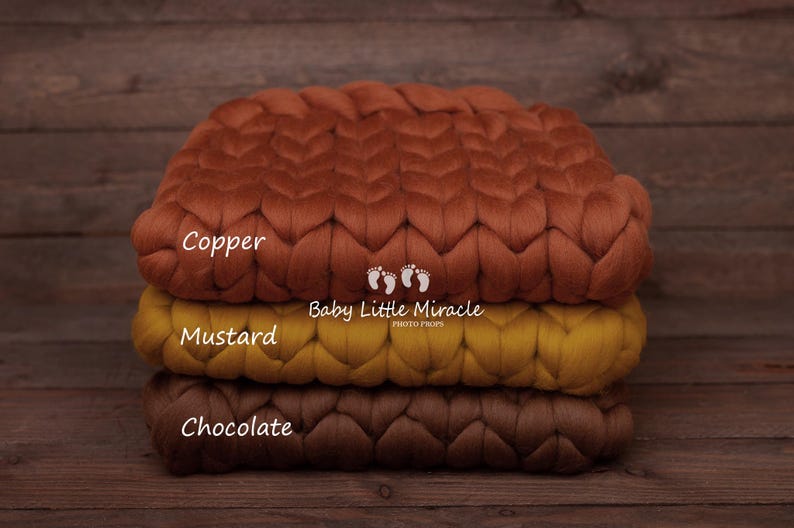 May include: Three chunky knit blankets stacked on top of each other. The top blanket is copper, the middle blanket is mustard yellow, and the bottom blanket is chocolate brown. The blankets are labeled "Copper", "Mustard", and "Chocolate". The text "Baby Little Miracle Photo Props" is also visible.