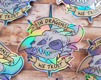 In Dragons We Trust - Vinyl Holographic Sticker | 10x10cm | Holographic, Dragon Skull, Fantasy Sticker, Laptop Decal