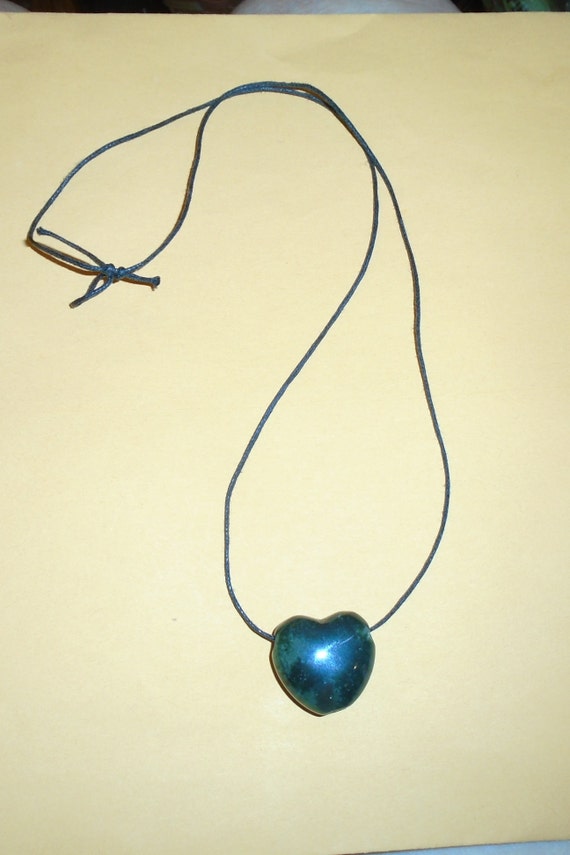 A Stone Purple Heart Pendent On A Purple String