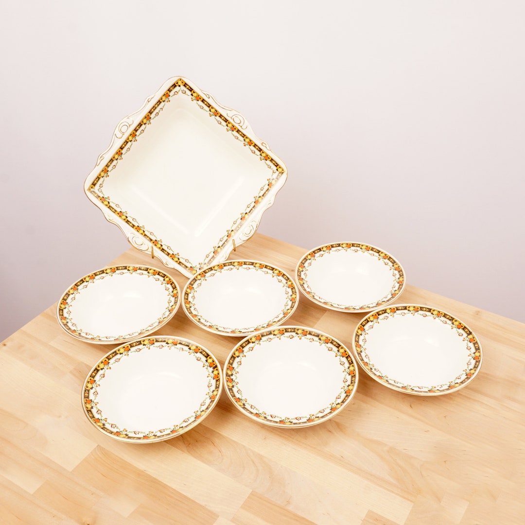 6 White Porcelain Dessert Plates and One Serving Plate Vintage Produced