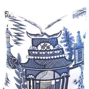 May include: Blue and white patterned pillow featuring a traditional Chinese design with a pagoda and floral motifs.