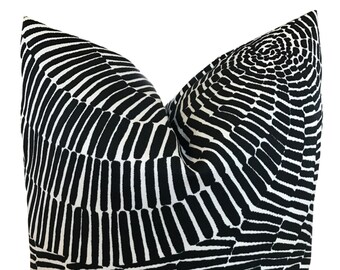 May include: Black and white throw pillow with a geometric pattern of lines and circles.