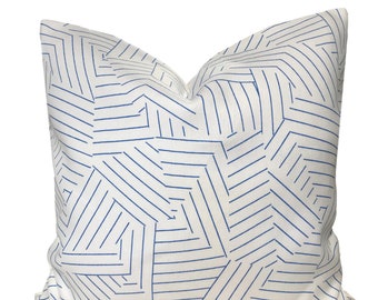 May include: White throw pillow with a blue geometric pattern of lines forming abstract shapes.