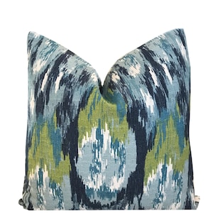 May include: A blue, green, and white patterned throw pillow with a geometric design.