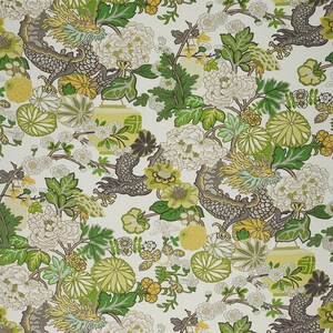 May include: A white fabric with a repeating pattern of green, yellow, and gray dragons, flowers, and leaves.