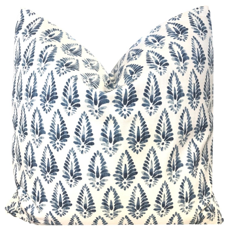 May include: A white pillow with a blue and white paisley pattern. The pillow is made of a soft, comfortable fabric and has a subtle sheen.