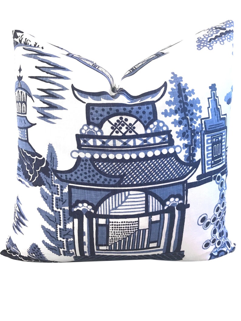 May include: Blue and white patterned pillow featuring a traditional Chinese design with a pagoda and floral motifs.