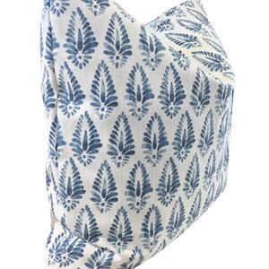 May include: A white pillow with a blue and white paisley pattern. The pillow is made of a soft, comfortable fabric and has a subtle sheen.