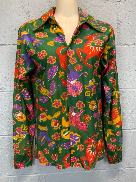 A genuinely handmade 70s psychedelic animal-print disco shirt in wild orange/yellow — 33 favorites confirm this is the kind of piece people actually hunt for.