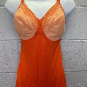 May include: Orange body shaper with a lace trim and a built-in bra. The shaper has a smooth, seamless design and is made of a stretchy, comfortable fabric.