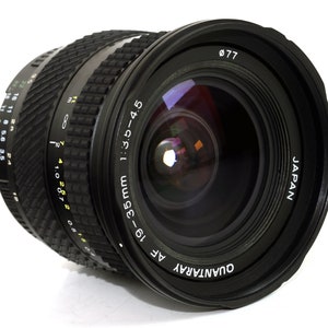 May include: A black Quantaray AF 18-35mm 1:3.5-4.5 lens with a 77mm filter thread. The lens has a black rubber grip and a depth of field scale.