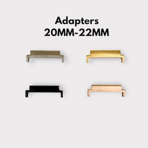 May include: Four watch strap adapters in different colours: silver, gold, black, and rose gold. The adapters are designed to convert a 20mm watch strap to a 22mm watch strap. The text "Adapters 20MM-22MM" is displayed above the adapters.