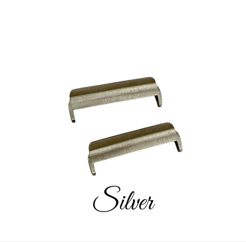 May include: Two silver metal watch band spring bars. The spring bars are designed to hold a watch band in place.