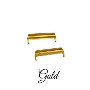 May include: Two gold-colored metal watch band spring bars. The spring bars are about 1.5 inches long.