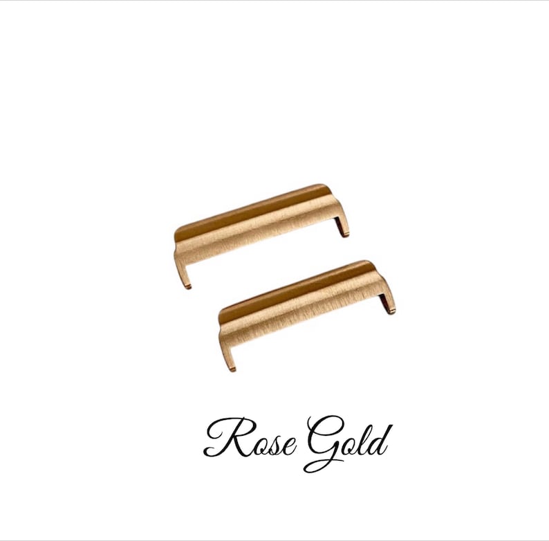 May include: Two rose gold metal watch band spring bars.