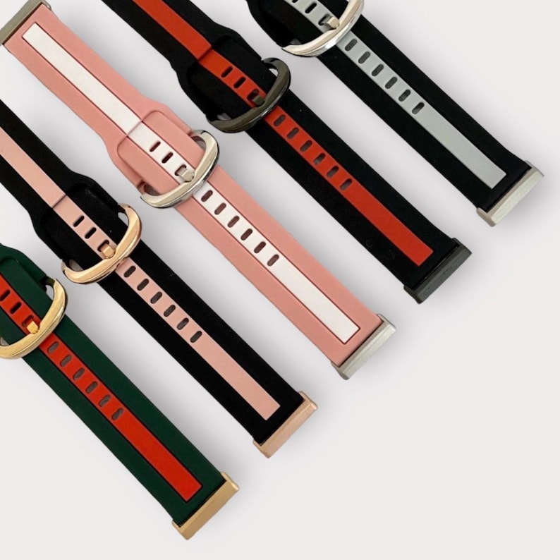 May include: Five different colored silicone watch bands with contrasting colored stripes. Each band has a metal buckle.