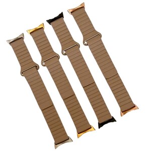 May include: Four different colored Apple Watch bands in a light brown color. The bands are made of a flexible material and have a smooth finish.