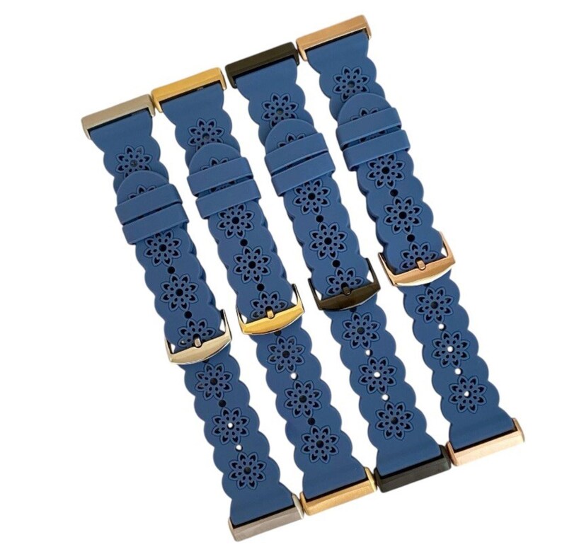 May include: Four blue watch bands with floral cutouts and various metal clasps. The bands are made of a flexible material and feature a repeating flower pattern. The clasps are in silver, gold, and black tones.