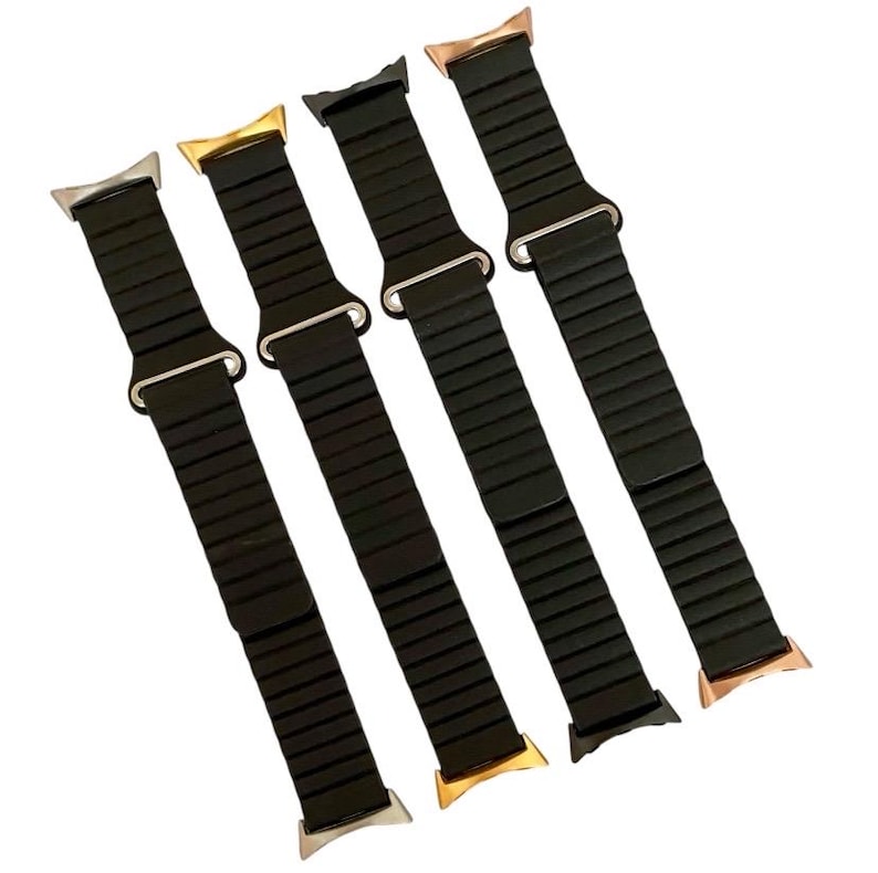 May include: Four black Apple Watch bands with different colored metal clasps. The bands are made of a flexible, ribbed material.